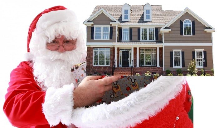 Santa holding a house