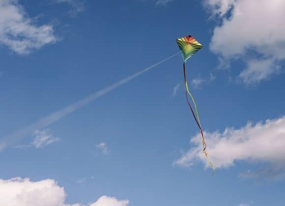 A diamond-shaped kite in flight